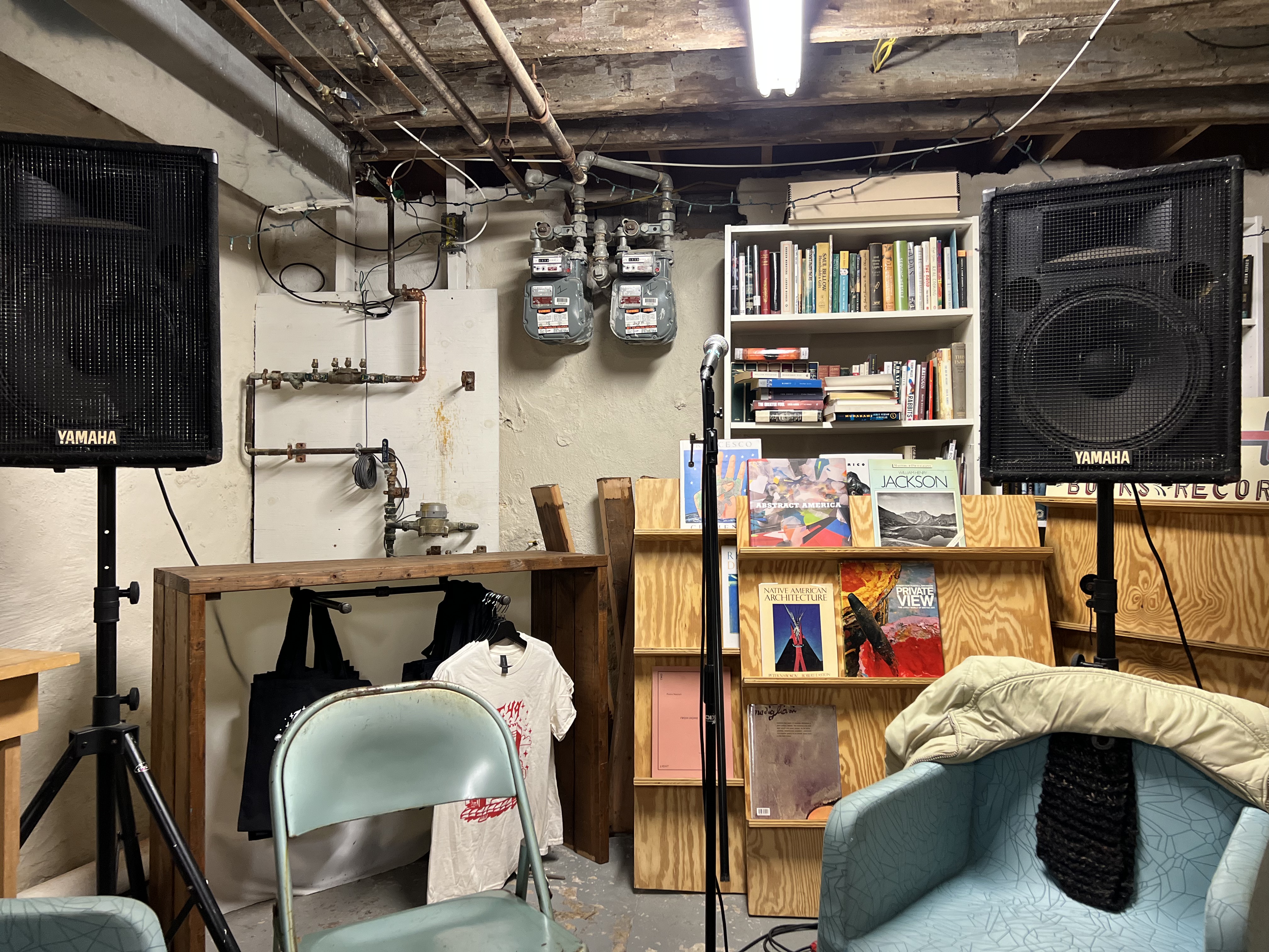 a microphone with two speakers in the basement of Lot 49 Books in Philadelphia, PA
